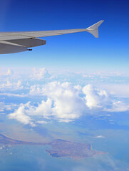 airplane wing and white clouds ideal for travel concept