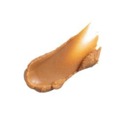 Trace of condensed milk close-up. Smear of caramel paste on a transparent background