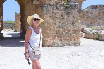Mature Woman Posing Among Ancient Ruins in Tunisia