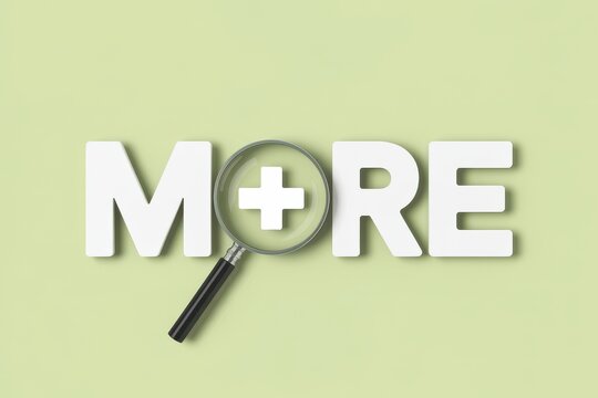 Close-up view of the word MORE with a magnifying glass focusing on the plus symbol, signifying growth, expansion, and additional benefits