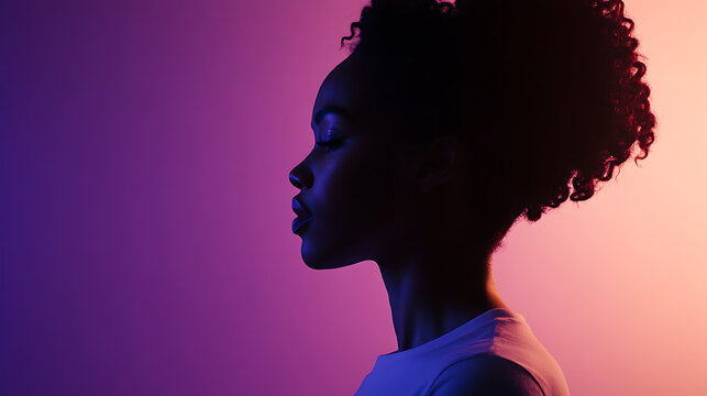 Profile of a woman with naturally curly hair set against a background illuminated with gradients of purple, blue, and peach tones.