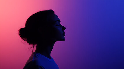 Silhouette portrait in gradient lighting. Captures a serene profile with eyes closed, reflecting a state of peace and contemplation. The colorful light adds depth.