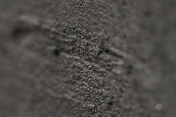 Close-up view of textured black surface showing intricate patterns and fine details in light