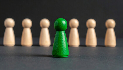 Wooden figurine at the front leading a line of others, walking forward, leadership and influence
