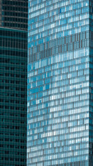 Fototapeta premium mirrored windows of the facade of an office building