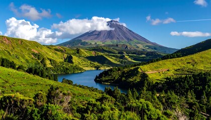 Lush valley with a tranquil lake nestled beneath a majestic volcano, showcasing a vibrant landscape of green hills and a clear sky.