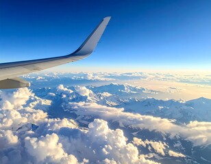 Majestic snow-capped mountains seen from a high-flying airplane, surrounded by fluffy clouds and a vibrant blue sky.
