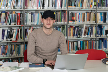 Man Working in Library With Cap on Head