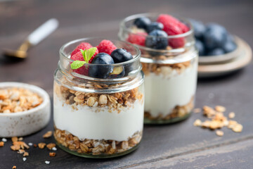 Healthy dessert for fitness and weightloss lifestyle: parfait with greek yogurt, granola, raspberries and blueberries