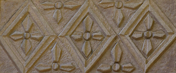Carved stone panel with geometric and floral patterns showcasing historical architecture and detailed craftsmanship