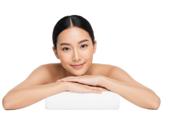 Young asian woman with radiant skin, dark hair pulled back, bare shoulders, reposed on forearms with a gentle smile in a transparent studio, soft diffused light, concept of spa wellness