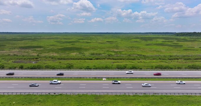 I-75 running through undeveloped Florida landscape with wetland vegetation.