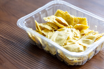 Raw Italian Ravioli Pasta on a Wooden Table