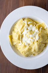 lose-Up of Italian Ravioli with Mozzarella and Olive Oil on a White Plate
