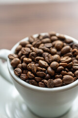 Coffee Beans in a Large White Cup on a Brown Table