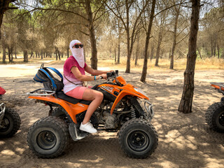 Woman Wearing Arabic Headscarf Riding Quad Bike in Tunisian Forest