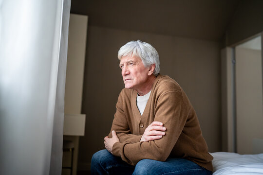 Desperate lonely elderly man sit staring blankly with detached empty gaze. Elderly depression, senior isolation, memory loss disease, age sickness, social abandonment, geriatric health, mental decline