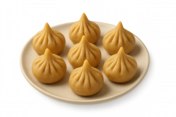 Indian modak sweet dumplings on a plate, traditional festive dessert for ganesh chaturthi celebration on transparent background