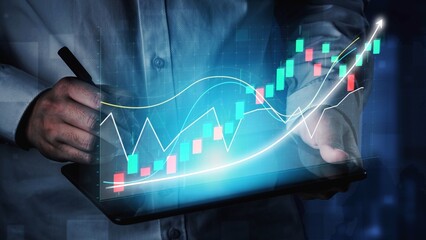 A person engages with a digital tablet displaying vibrant stock market charts and graphs, representing financial trends and trading strategies in a modern environment. Copula
