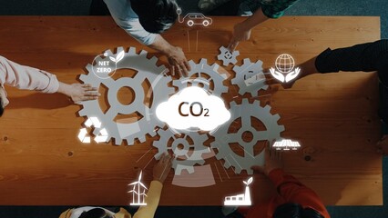 A diverse group of individuals collaborates over a table, arranging gears and visualizing concepts...