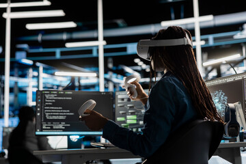 Data center technician using virtual reality technology to visualize artificial intelligence neural networks. Server room employee using VR headset equipment to oversee AI systems