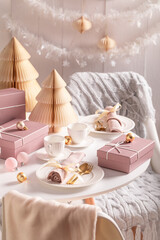 Wonderful table set for Christmas with bubbles and pink gifts.