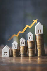 House prices are rising with an upward golden arrow showing property market growth over time, stacked coins increase with building models.