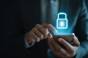 Secured access on smartphone, ensuring data protection. Businessman securing smartphone with digital safety padlock overlay.
