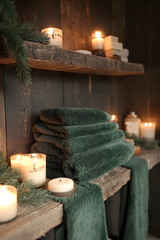 Cozy Bathroom Shelf with Green Towels and Candles