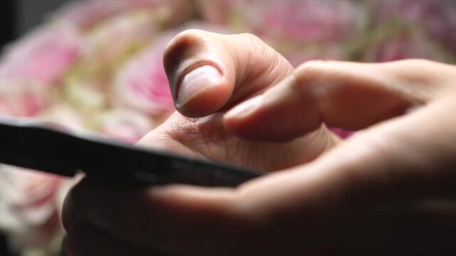 A modern gadget in the hands of an IT professional or businessman.
Using a smartphone for work.
An office worker scrolling through social media on a smartphone.
Online work and business