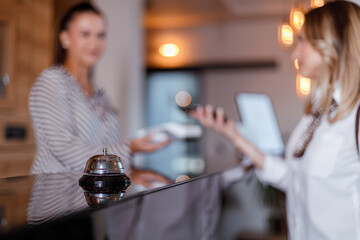 Guest checking in at a modern hotel reception with friendly staff member present