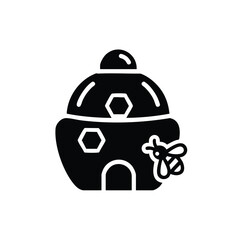 Obraz premium Simplified black and white of a traditional beehive with a small bee flying nearby, representing nature and pollination concepts