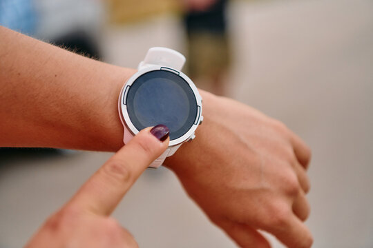 Close Up Woman Analyzing Workout Data on Smartwatch Post Run.