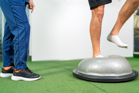 Person balancing on bosu ball during physical therapy