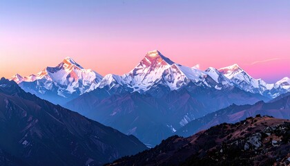 Panoramic view of snow-capped mountains at sunrise, showcasing a range of peaks bathed in soft pink and purple hues against a clear sky; layered mountain slopes descend into valleys