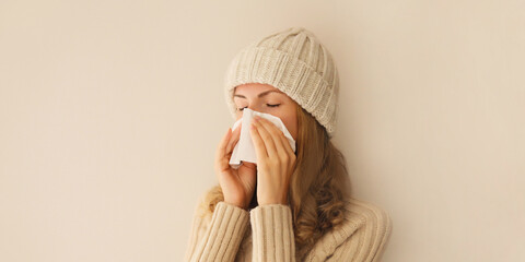 Sick exhausted young woman sneezing blow nose using tissue, unhealthy suffering girl feels unwell