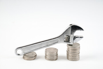 wrench and coin, conceptual image for fix and cost