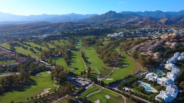 Aerial 4K drone view of golf course near Marbella Spain with fairways and greens