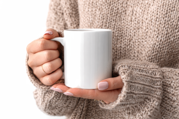 Close-up shot of a person holding a white mug with both hands, wearing a beige sweater.