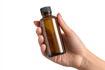 Hand holding a brown glass bottle with black cap on white background.