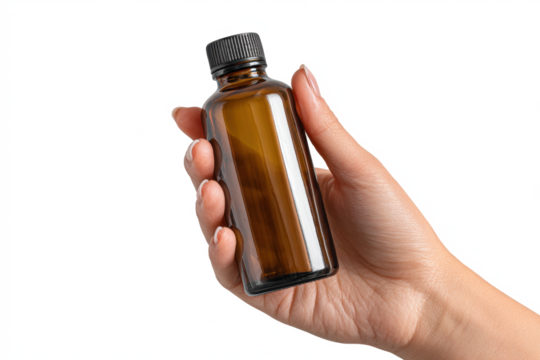 Hand holding a brown glass bottle with black cap on white background.