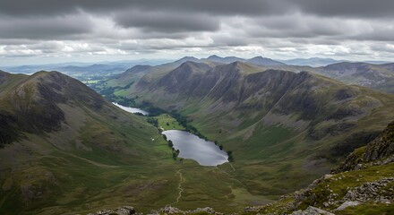 Scenic mountain landscape with lake valley under cloudy sky aerial view