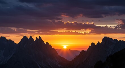 Naklejka premium Dramatic sunset over mountain range with vibrant sky and silhouettes