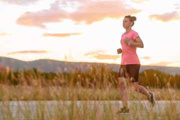 Determined Athlete Running in the Sun amidst Beautiful Nature