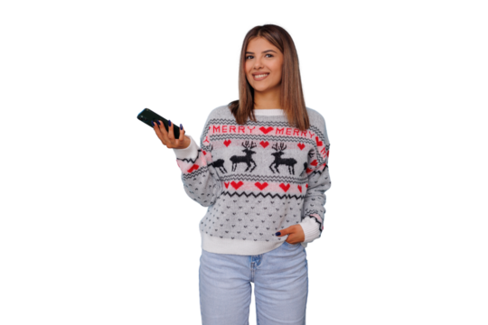 Woman smiling wearing christmas sweater holding smartphone showing festive holiday season spirit
