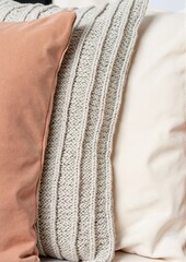 Tactile psychotherapy concept. Decorative pillows of various textures in neutral colors on a sofa.
