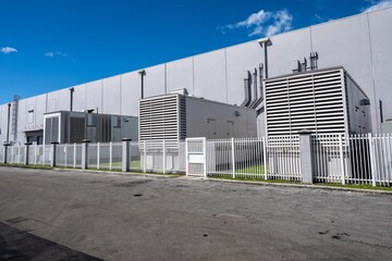 Standby diesel generators outside warehouse building