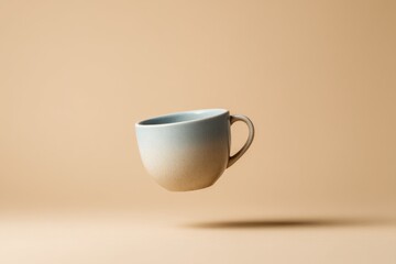 Fototapeta premium Elegant ceramic mug with a gradient finish floating gracefully against a warm beige backdrop