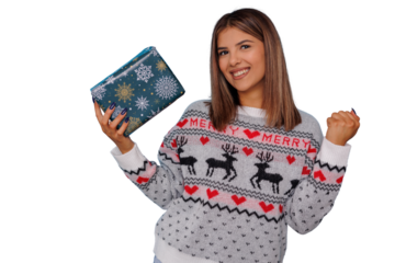 Happy young woman celebrating christmas, wearing a festive sweater and holding a holiday gift box