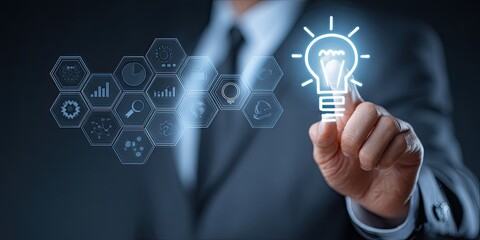 A businessman's hand hovers over a glowing lightbulb graphic overlaid on a futuristic interface of data icons